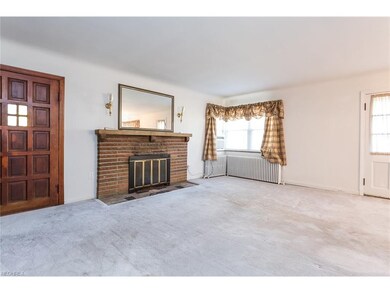 Front door into living room with woodturning firep