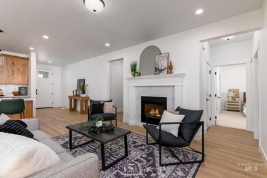 Living area featuring light wood-style flooring, recessed lighting, and a fireplace