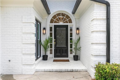 View of exterior entry with brick siding