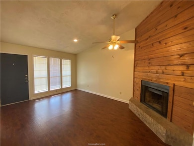 Unfurnished living room with lofted ceiling, baseb