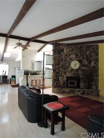 Entry to Open beamed ceiling living room