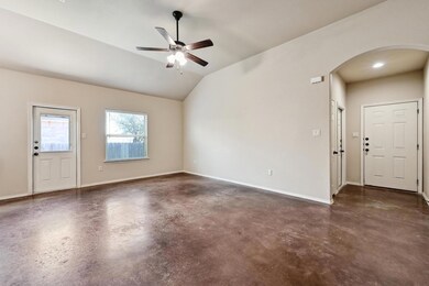 Unfurnished living room with arched walkways, cei