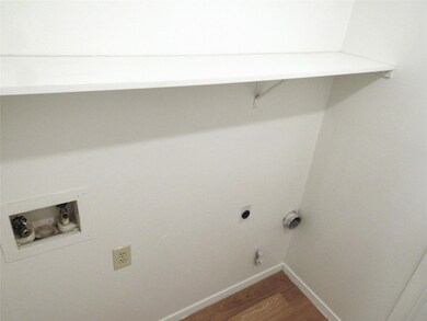 Washroom featuring wood finished floors, washer hookup, and gas dryer hookup