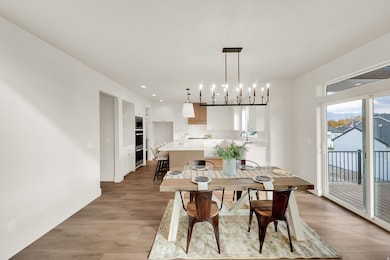 Dining space featuring light wood finished floors, a chandelier, and recessed lighting
