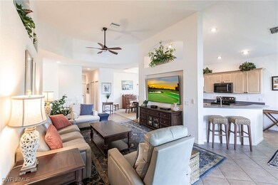 Living area with visible vents, ceiling fan, light