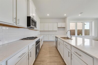 Kitchen featuring light stone countertops, backspl