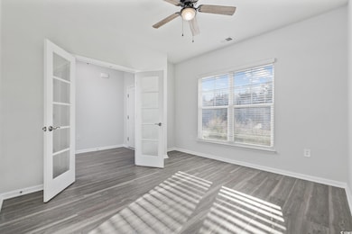 Unfurnished bedroom featuring dark wood-type floor
