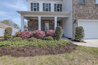 View of front facade with brick siding, a porch, a