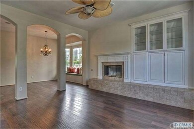 The living room has distressed wood floors, built-