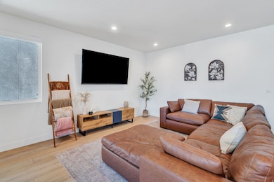 Living area featuring recessed lighting and wood finished floors