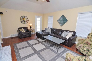 The great room showcases vaulted ceilings and hard