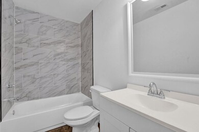 Full bath with toilet, vanity, and  shower combination