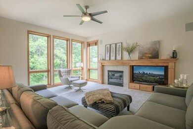 Family room offers tile surround gas fireplace wit