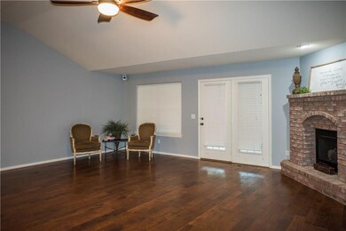 Spacious Family Room has woodscrapped flooring and Gas Log Corner Fireplace