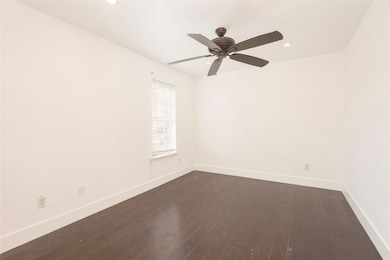 Unfurnished room featuring dark wood-style flooring, recessed lighting, and a ceiling fan