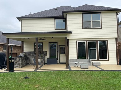 Big backyard with extended patio and outdoor kitchen