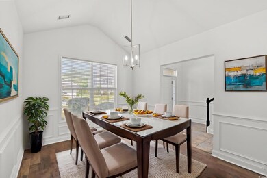 Dining room featuring a decorative wall, wainscoti