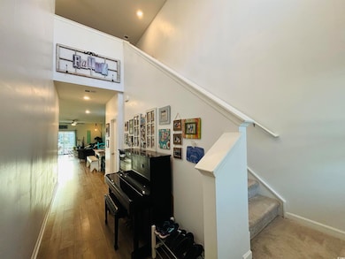 Stairs with hardwood / wood-style floors, a toweri