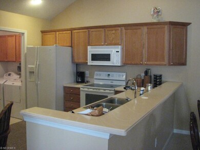 Eating bar in kitchen.  Oak cabinets.  Corian coun