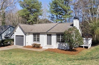 Ranch-style house with a front lawn, concrete driv