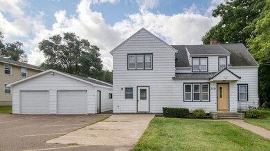 FRONT OF TRI-PLEX WITH VIEW OF FRONT OF 2-CAR GARAGE