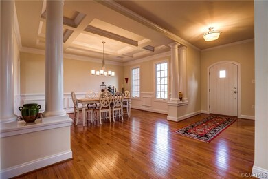 Foyer with architectural columns and arched front