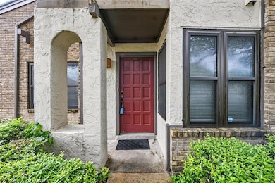 Doorway to property featuring stucco siding