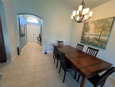 Dining area featuring arched walkways, a chandelie