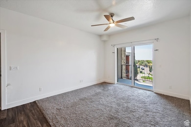 Spare room with a ceiling fan, a textured ceiling, and wood finished floors