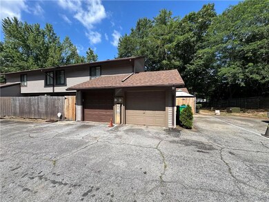 View of front of property featuring roof with shingles and a garage