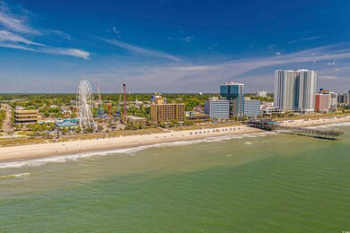 Birds eye view of property with a beach view, a ci