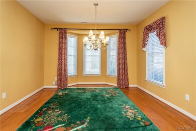 Dining Room with Bay Window, Hardwood Flooring, an
