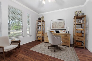 The office/study has been virtually staged, as they owners are currently using it as a second playroom.  The windows overlook the front yard.  The room can be enclosed by the double french doors for added privacy.