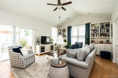 Living room featuring lofted ceiling and light har