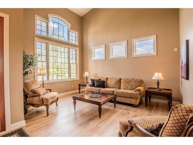 Grand vaulted 2-story living room highlights wall 