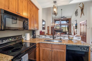 Kitchen featuring black appliances, sink, hanging