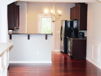 Kitchen with a kitchen breakfast bar, dark wood-st