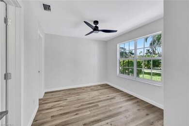 Empty room featuring visible vents, baseboards, wo