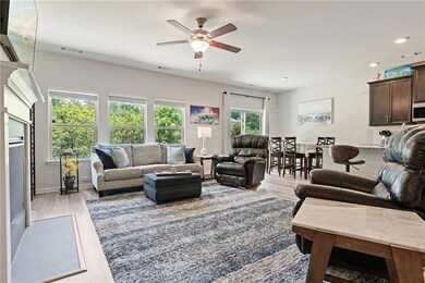 Living area featuring ceiling fan, light wood-style floors, and recessed lighting