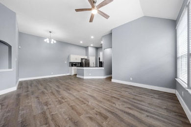 Unfurnished living room featuring baseboards, lof