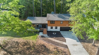 Tri-level home featuring driveway and an attached garage