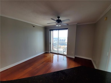 Unfurnished room featuring ceiling fan, hardwood / wood-style flooring, and ornamental molding