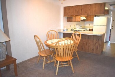 View of Dining area, breakfast bar and kitchen.  B