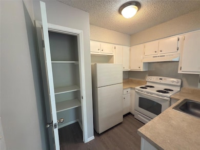 Kitchen with white appliances, under cabinet rang