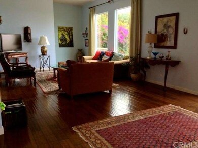 Open spacious living room with wood flloors, high 