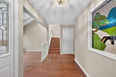 Welcoming entry with stain glass mural and staircase