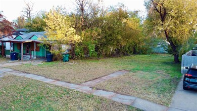 View of grassy yard with covered porch