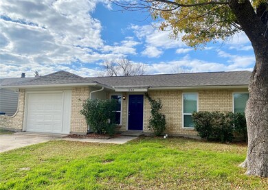 Single story home with a garage and a front lawn