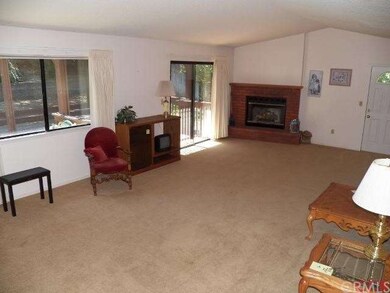 Spacious living room with gas log fireplace.