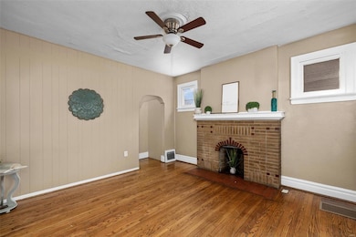 Upon entry, be greeted by hardwood floors, soaring ceilings, and a charming masonry fireplace.